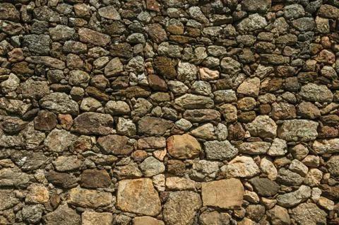 Old wall made of large rough stones Stock Photos