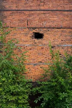 Old wall made of red bricks. Hole in the wall Stock Photos