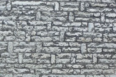 Old wall made of white interlaced stone. Background. Horizontal Stock Photos