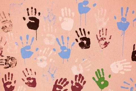 Old wall with multi-colored prints of palms. background for design Fotos Stock