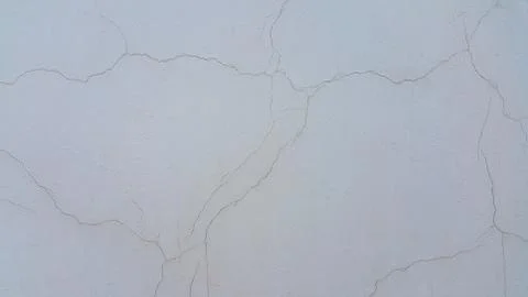 Old wall outside, painted with gray paint, the Paint of which has dried Stock Photos