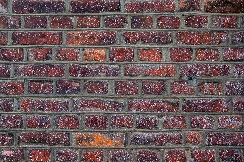 Old wall of red brick, with small spots of white paint Stock Photos