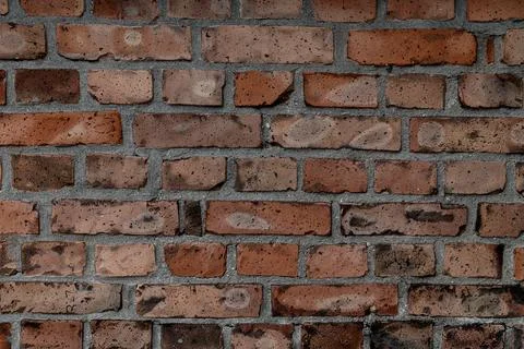 Old wall with red bricks and concrete. Abstract background texture. Stockfoto's