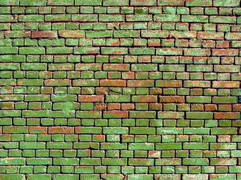 Old wall with red bricks painted in green. Stock Photos