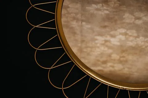 Old wall reflection in golden mirror on black background Stock Photos