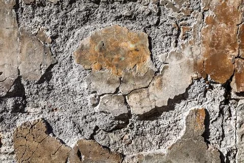Old wall showing rough textured concrete and peeling plaster Stock Photos