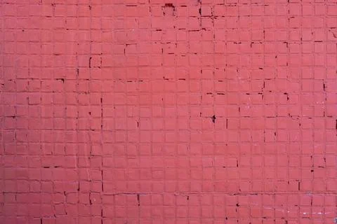 Old wall with small ceramic tiles painted with red paint. rough surface textu Foto stock