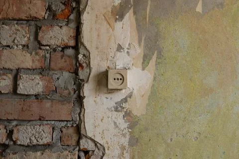 Old wall with socket under renovation. Brickwork and old plaster Stock Photos