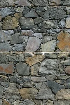 Old wall of stone shell rock of arbitrary shape. Stock Photos