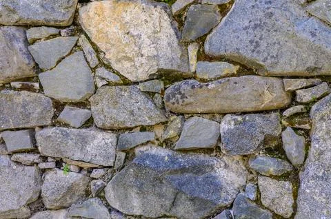 Old wall of stone shell rock of arbitrary shape. 4 Stockfoto's