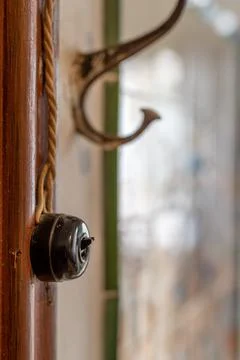 Old wall switch and coat rack, vertical photo Stock Photos