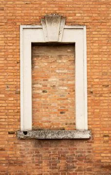 Old wall with a window closed with bricks, Ferrara Italy Stock Photos