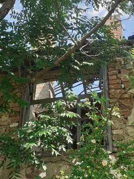 An old wall with a window in the middle Stock Photos