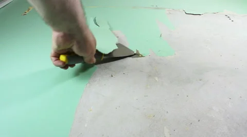 Old wallpaper stripping by man doing DIY re-decorating low angle view close up Stock Footage 55867374