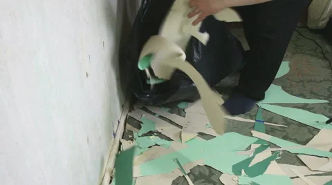 Old wallpaper stripping by man doing DIY disposing of stripped paper. Stock Footage 55867487