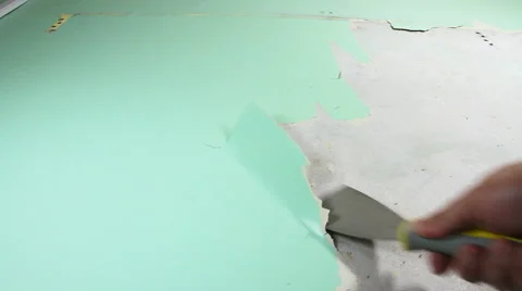 Old wallpaper stripping by man doing DIY re-decorating low angle close up Stock Footage 55867684