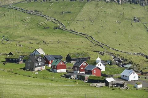 Old walls bordering the path of the sheep at the sheep drive, meadows, houses in Stock Photos
