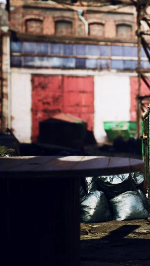 Old warehouse area with discarded items and a table in the foreground Stock Footage 338425438