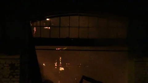 Old warehouse on fire at night Видео 75525955