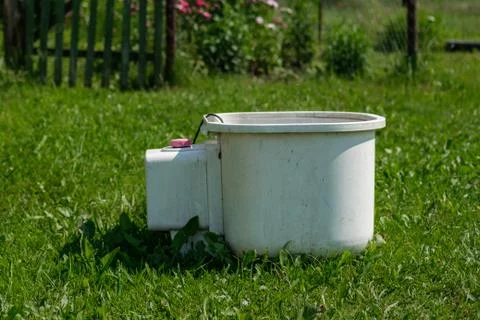 An old washing machine is standing on the grass. Stock Photos