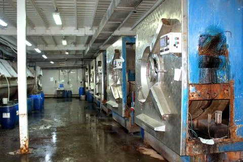 Old washing machine workshop with old washing machines and water barrels Stock Photos