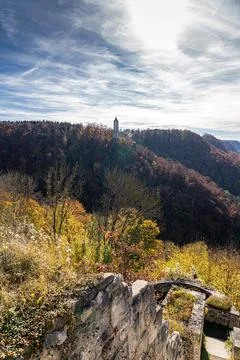Old watchtower on a hill in the middle of the autumn forest Stock Photos