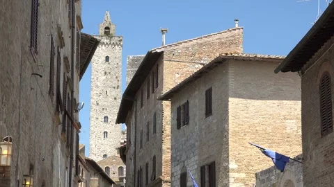Old watchtower rises above small town houses, medieval lookout - Lookout Tower Vídeo Stock 339815289