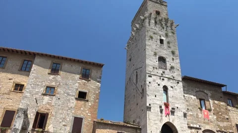 Old watchtower rises above small town houses - Lookout Tower and Ancient Scene Vídeo Stock 339815300