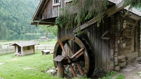 Old Waterwheel outside small mountain hut at lake Steirischer Bodensee Stock Footage 112895581