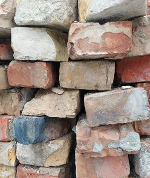Old weathered brick wall texture with red and orange stones Stock Photos