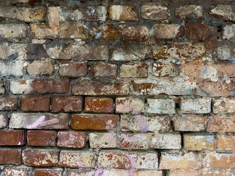 Old weathered brick wall texture close-up with graffiti traces, grunge urba.. Photos