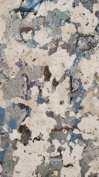 An old, weathered concrete wall on which there used to be some old graffiti Stock Photos