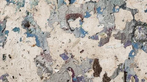 An old, weathered concrete wall on which there used to be some old graffiti Stock Photos
