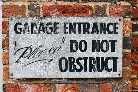 Old weathered do not obstruct sign on worn old brick wall Stock Photos
