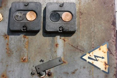 Old weathered electric button switch on a rusted door Stock Photos