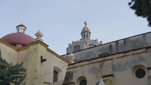 Old weathered facade of the san juan bautista parish church with its domes 스톡 동영상 340564053