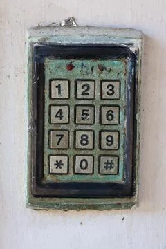 Old weathered industrial security access control keypad with worn numeric b.. Stock Photos