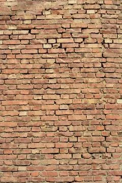 Old weathered red brick wall texture in a vertical full frame background Stock Photos