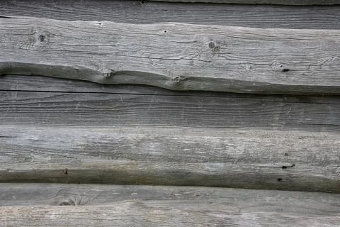 Old weathered rough plank barn wall. Stock Photos