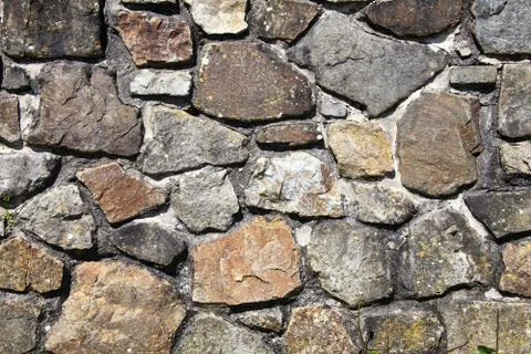 Old weathered rustic stone brick wall background Stock Photos