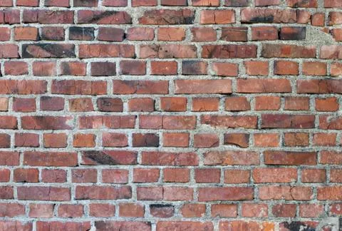 Old weathered stained red brick wall Stock Photos