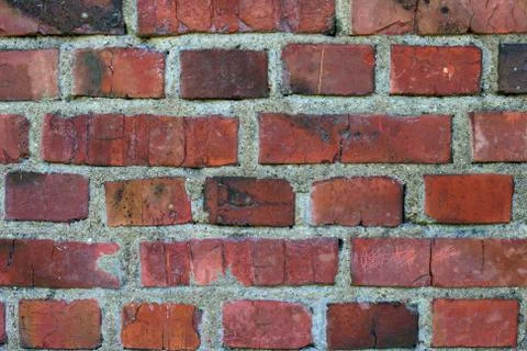 Old weathered stained red brick wall Stock Photos