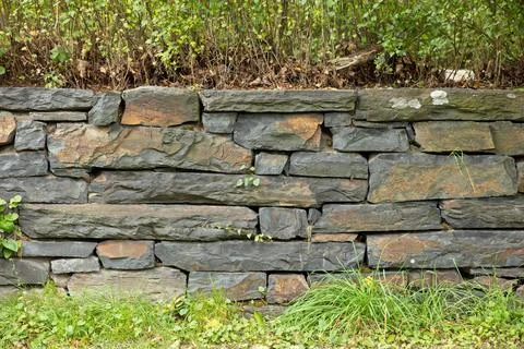Old weathered stone wall. Stock Photos