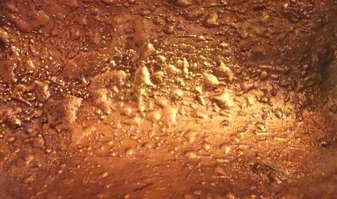 Old weathered textured bubbled surface painted in gold with copy space Stock Photos