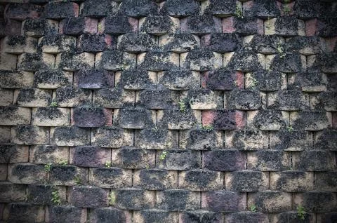 Old weathered wall with bricks turned into black Foto stock