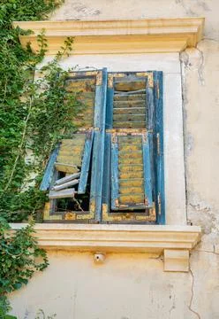 Old weathered window with broken shutters. Istria, Croatia. Stock Photos
