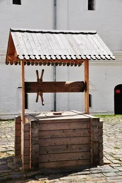 Old well. The base is made of square timber. Stock Photos