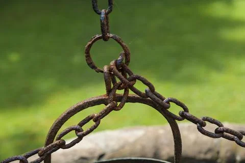 Old well bucket with rusty chain, life concept from a century ago. Stock Photos