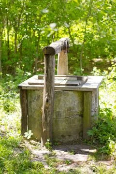 Old well in the forest Stock Photos