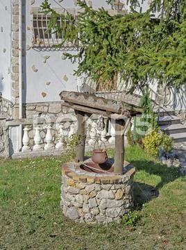 Old well in the yard Stock Photos